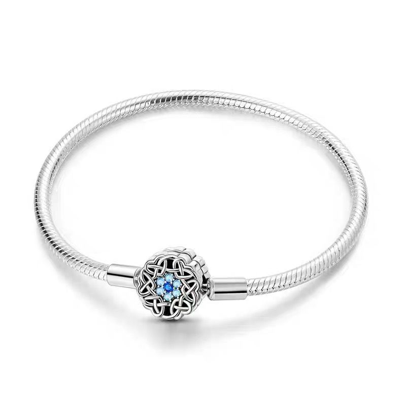 Celtic Knot Blue CZ Clasp Charm Bracelet — polished 925 sterling silver snake chain with round oxidised celtic knot clasp set with blue cubic zirconia accents